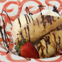 The Fried Banana · Wrapped in a crispy cinnamon flour tortilla & drizzled with chocolate sauce, served with van...