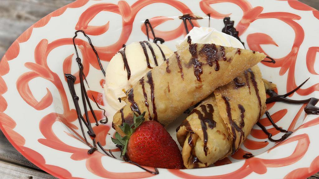 The Fried Banana · Wrapped in a crispy cinnamon flour tortilla & drizzled with chocolate sauce, served with vanilla ice cream