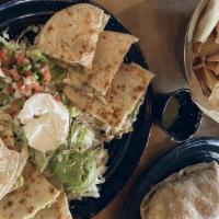Quesadillas · Served with guacamole and sour cream. Flour tortillas stuffed with cheese and your choice of...