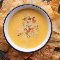 Chile Con Queso · Blend of melted cheese with diced jalapeño.