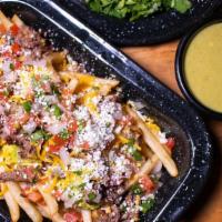 Famous Carne Asada Fries · French Fries topped with guacamole, carne asada, cheddar cheese, pico de gallo, and queso fr...