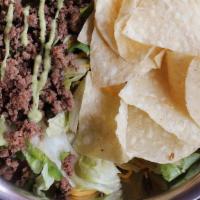 Texas Taco · Iceberg Lettuce, Tomatoes, Red Onions, Cheddar, Tortilla Chips, Spicy Texas Taco Meat with A...