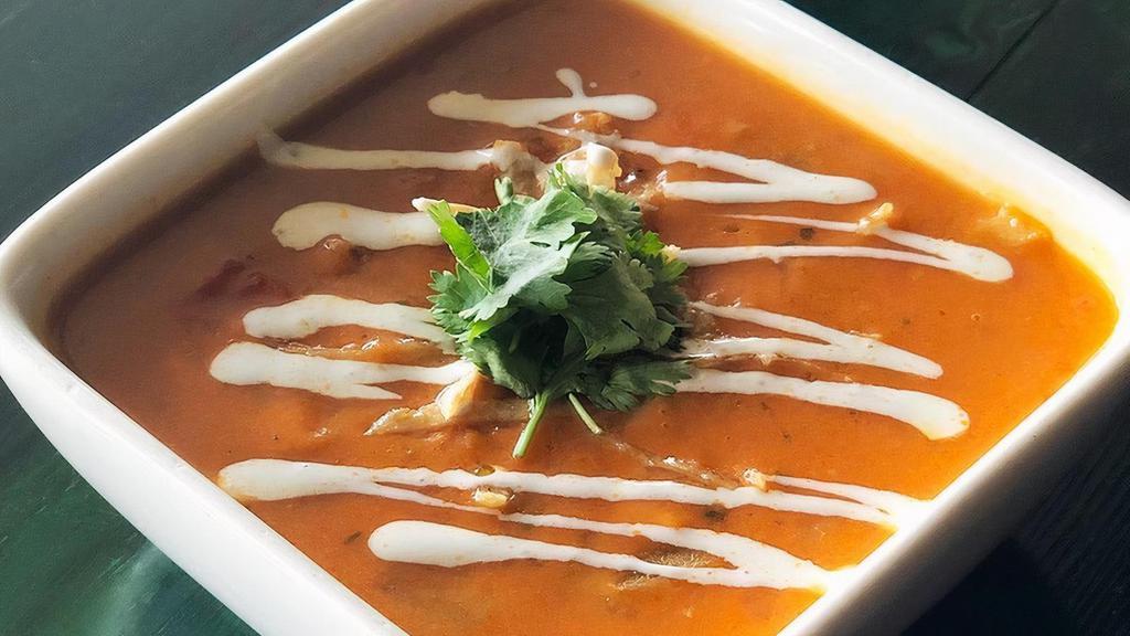 Chicken Tortilla Soup · A spicy, rich soup with shredded chicken, roasted green chiles, crushed tomatoes and corn masa.