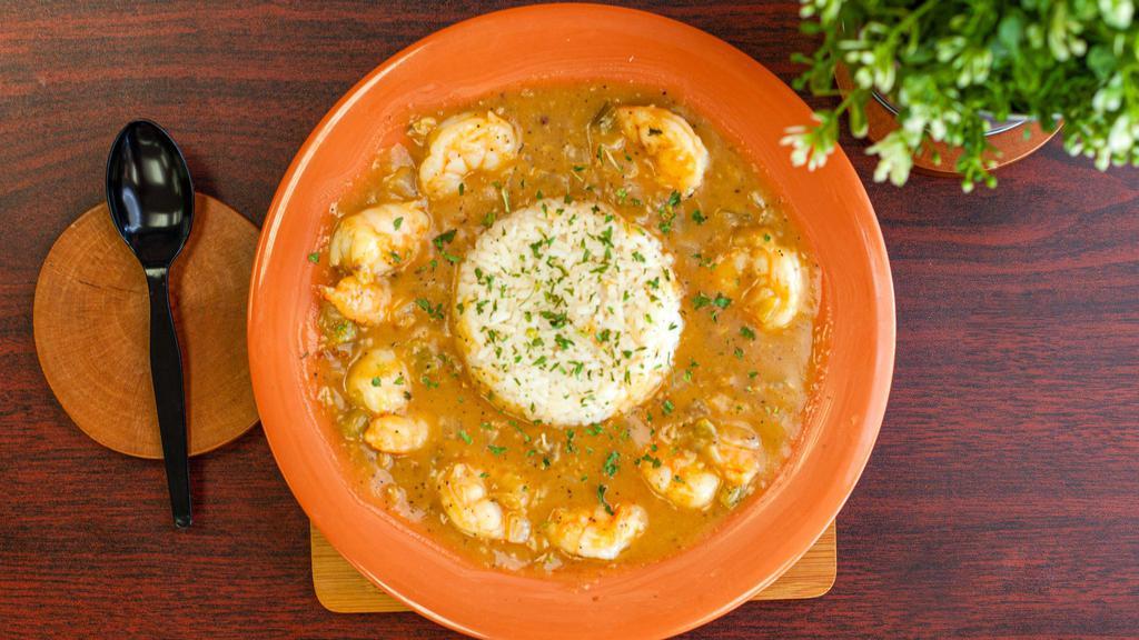 Shrimp Etouffee · Savory combination of grilled shrimp in a rich brown roux consisting of fresh onions and bell peppers. Served over a bed of white rice or dirty and one side item.