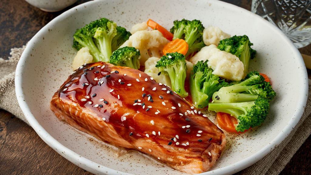 Teriyaki Salmon Bowl · A popular Japanese dish of braised and flaky salmon topped with our sweet teriyaki sauce. This dish is served with a side of white rice.