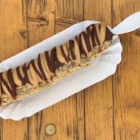 Peanut Butter Pie Banana · A frozen banana dipped in a vegan chocolate with a graham cracker crust and topped with crea...