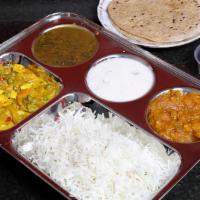 Thali Platter · Includes rice, lentils, two side vegetables of the day. Served with two chapatis and sweet.