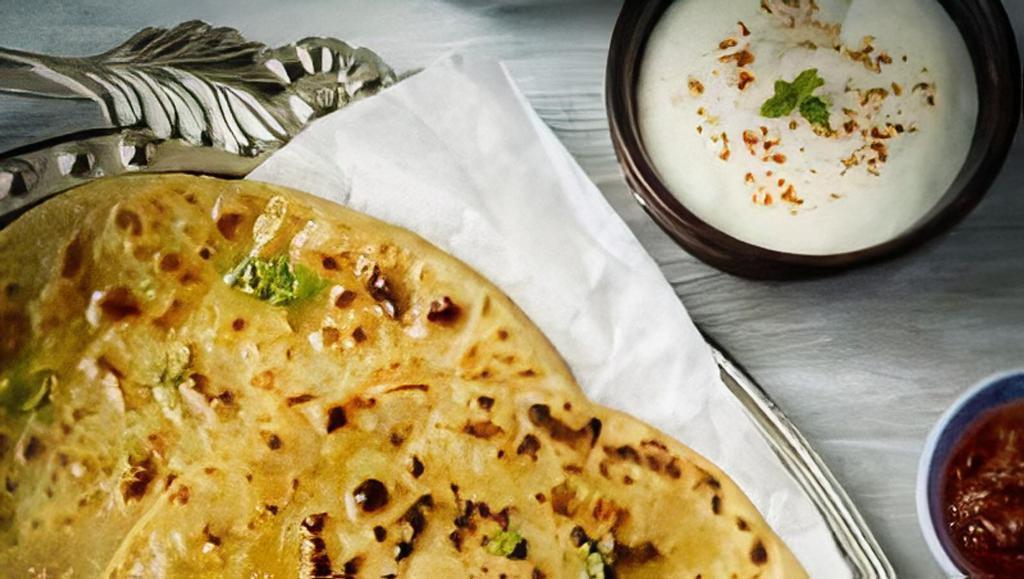 Aloo Paratha Platter · Two cauliflower / potato stuffed flat breads served with chickpeas and yogurt.