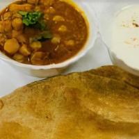 Chana Poori · Two whole wheat, fried flat breads served with chickpeas and yogurt.