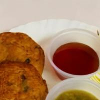 Aloo Tikki · Two spiced potato patties served with green chili and tamarind sauce.