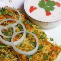 Vegetable Biryani · Basmati rice cooked with mixed veg and cashews. Served with raita (yogurt with veggies).