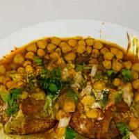 Aloo Tikki Chaat · Two potatoes patties topped with chickpeas, onions, yogurt, green chili and tamarind sauce.