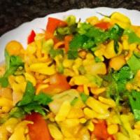 Bhel Poori · Rice puffs mixed with chopped onions, potatoes, tomatoes, and chickpeas with green chili and...