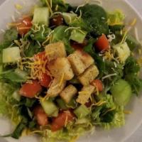 Side Salad · Garden Fresh Romaine, diced tomatoes, cucumbers, cheese, seasoned croutons, served with your...