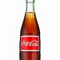 Mexican Coca-Cola · Pair your next meal with a cold Coca-Cola! Subtle notes of vanilla sweetened with real cane ...