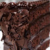 Chocolate Fudge Cake · Moist chocolate fudge cake, layered with rich buttercream, covered in milk chocolate shavings