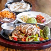 Fajitas · Mesquite grilled, sizzling with grilled onions, bell peppers, frothy garlic butter.