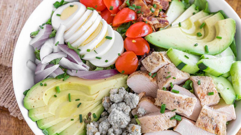 Chicken Cobb Salad(Gf) · Chopped lettuce, grape tomatoes, avocado, bacon, rosemary chicken, cage-free egg, Roquefort cheese, chives, and red wine vinaigrette.