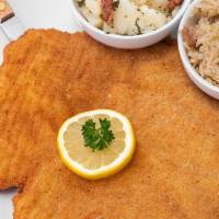 The Classic Schnitzel · Classic Austrian dish, pork or chicken, lightly breaded, served with Austrian potato Salad a...