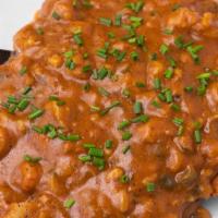 Cajun Schnitzel · Our pork Weinerschnitzel topped with spiced rice, and smothered in our Haus-made crawfish et...