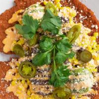 Tex-Mex Schnitzel · Street corn, barbacoa, guacamole, pickled jalapeños, cotija cheese, chipotle aioli, and cila...
