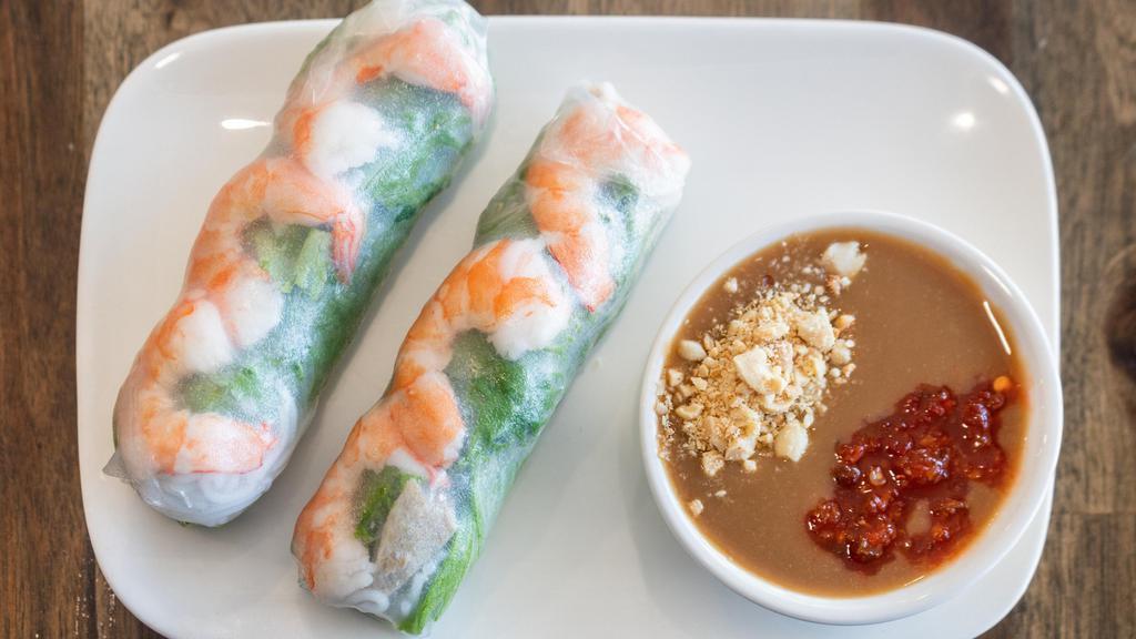 Spring Rolls / Goi Cuon · Garlic shrimp and pork rolled in fresh rice paper with lettuce, mint, and rice noodles. Dipped in peanut sauce.