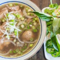 Beef Pho / Pho Bo · Rice noodles in mama's signature Pho broth with tender beef brisket, meatballs, and thinly s...