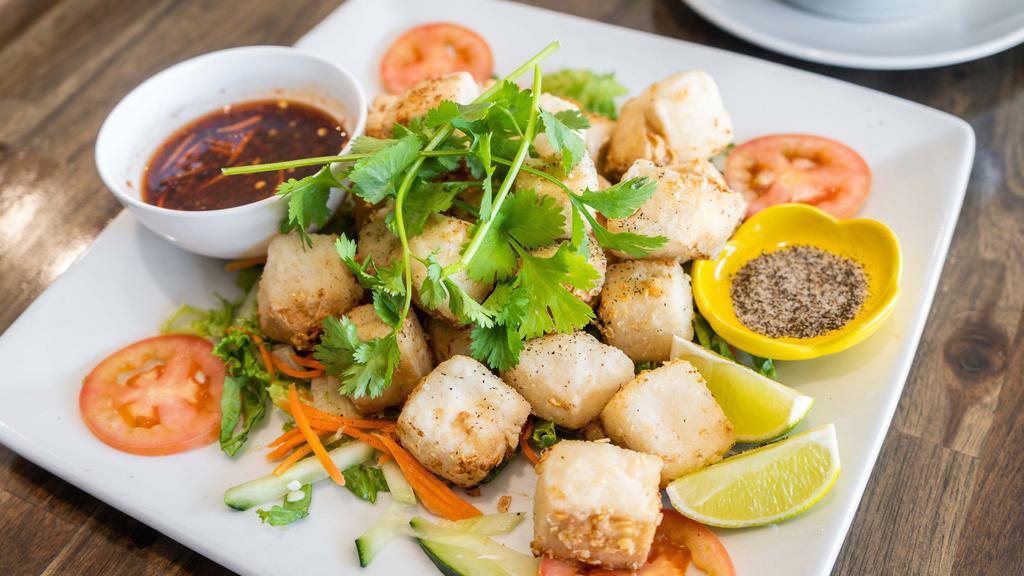 Shaken Tofu / Tau Hu Luc Lac · Vegetarian. Cubes of soft tofu lightly battered in garlic spices and tossed over high flame. Served over shredded lettuce with a side of salt and pepper lime dipping sauce.