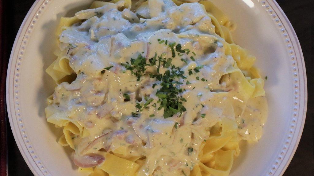 Pappardelle Carbonara · Pancetta, red onions, and homemade Pappardelle pasta swirled in Russo’s homemade Pecorino Romano cream sauce.