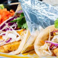 Tacos De Pescado · Hand-battered and fried tilapia filets wrapped in flour tortillas, served with tartar sauce,...