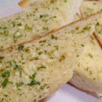 Garlic Bread · Fresh baked bread generously brushed with house garlic butter and toasted golden.