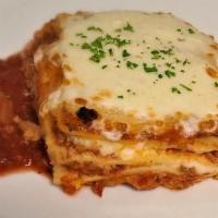 Lasagna Bolognese · Layers of meat sauce, béchamel, parmesan, and mozzarella cheeses, baked until bubbly and gol...