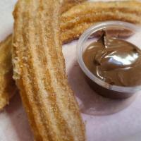 Italian Churro · Two footlong Polenta Churros rolled in cinnamon sugar and served with Nutella for dipping.