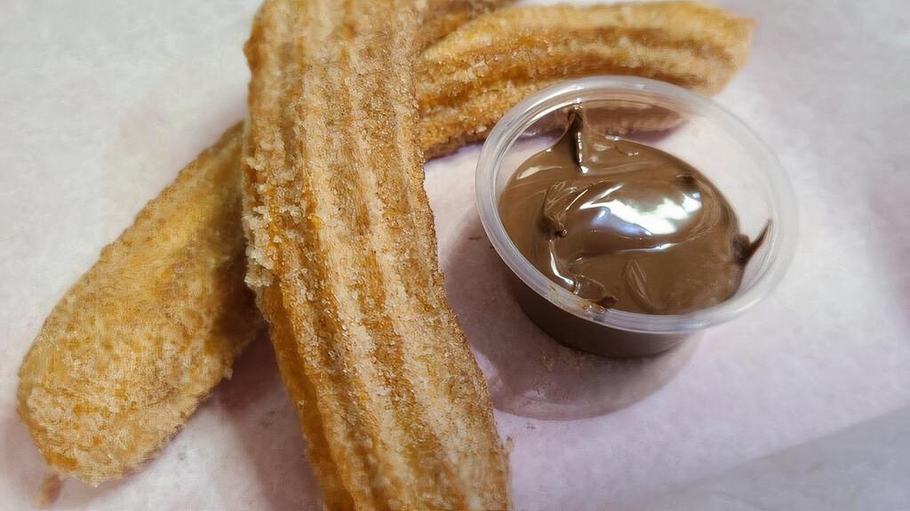 Italian Churro · Two footlong Polenta Churros rolled in cinnamon sugar and served with Nutella for dipping.