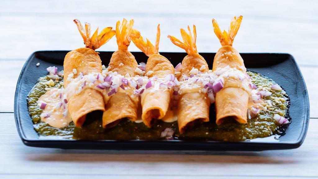Taquitos De Camaron · Five crispy shrimp taquitos served on a bed of tomatillo sauce then topped with a delicious creamy mango habanero sauce, queso fresco, and diced red onion.