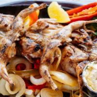 Quail · Marinated in our house sauce and served on a bed of grilled onions. Served with guacamole, p...