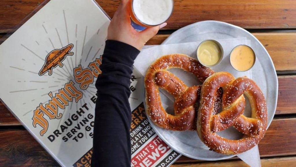 Two Big Soft Pretzels · Buttered, salted, and toasted and served with your choice of two dipping sauces.