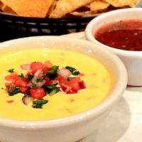 Tostada Chips & Queso · A big ass bowl of queso served with salsa.