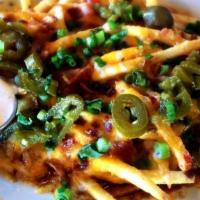 Cheese Fries Surprise · Loaded with cheddar-jack, bacon, spiced beef, chives and jalapeños, served with ranch and a ...