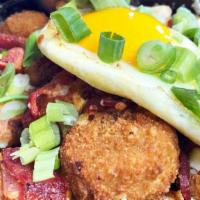 Loaded Rocket-Tots · Jalapeño potato tots topped with cheddar-jack, goat cheese, bacon, chives, and fried egg.