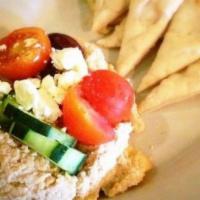 Hummus & Pita · Hummus topped with Greek salad. Served with warm pita bread.