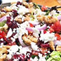 Lauren'S Goat Cheese Salad · Spring mix topped with goat cheese, walnuts, tomatoes, sliced red onions, cranberries and se...