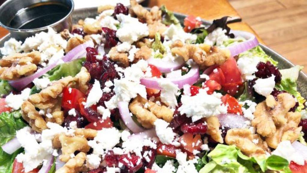 Lauren'S Goat Cheese Salad · Spring mix topped with goat cheese, walnuts, tomatoes, sliced red onions, cranberries and served with balsamic vinaigrette.