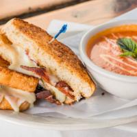 Grilled Cheese & Tomato Bisque · Three cheese blend and applewood smoked bacon on sourdough served with warm tomato soup.
