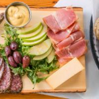 Charcuterie · The perfect rotating artisanal meat and cheese board served with all the complements.