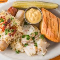 The German Plate · Two grilled bratwurst served with German potato salad, sauerkraut, toasted bread and spicy m...