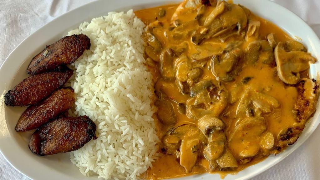 Mushroom Chicken Breast · Our grilled chicken breast in a creamy mushroom sauce. Comes with a side of white rice and sweet plantains.