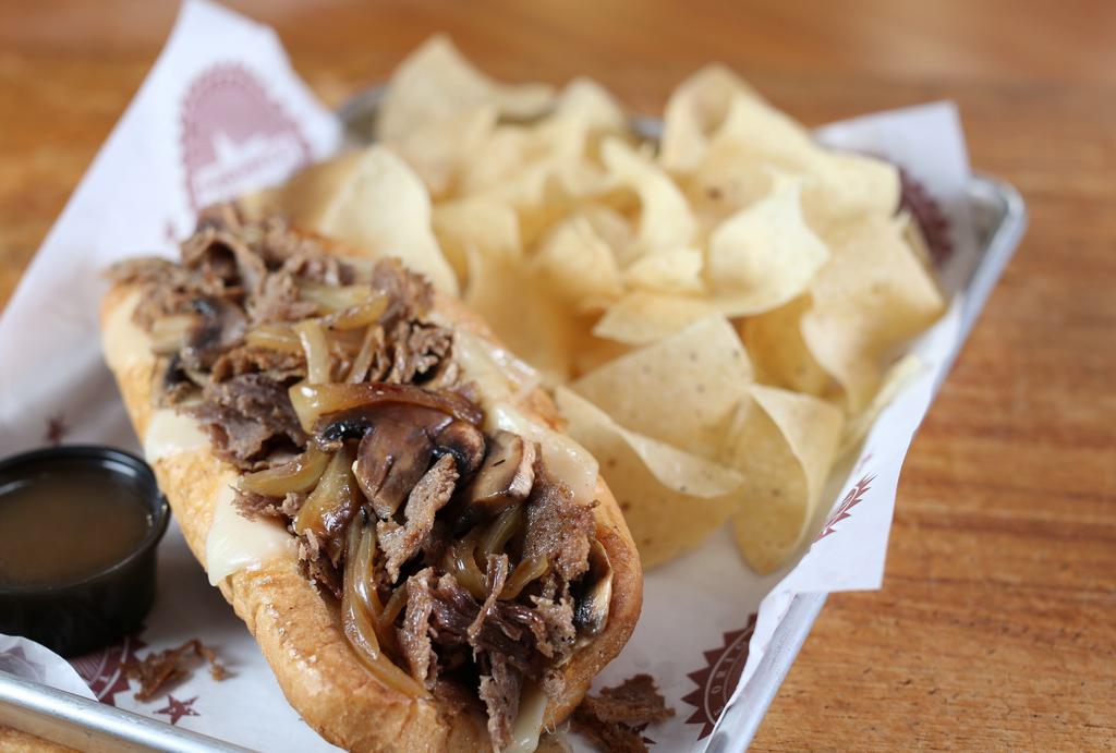 The French Dip · Beef or Chicken, Grilled Onions, Swiss, Mushrooms, Au Jus Dipping Sauce on Side.