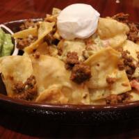 Tex-Mex Loaded Nachos · Monterrey Jack cheese, white queso, tortilla chips, shredded lettuce, sour cream, jalapenos.