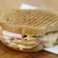 The Cubano · Smoked turkey, ham, swiss cheese, sweet and spicy pickles, pickled red onions and dijon must...